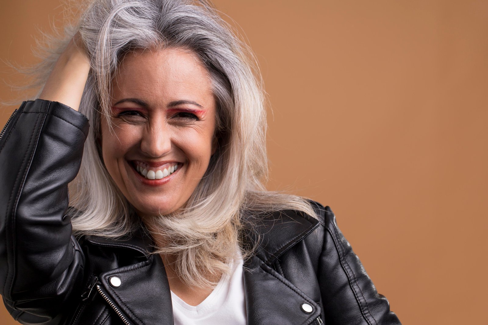 Woman washing thinning hair with volumizing shampoo