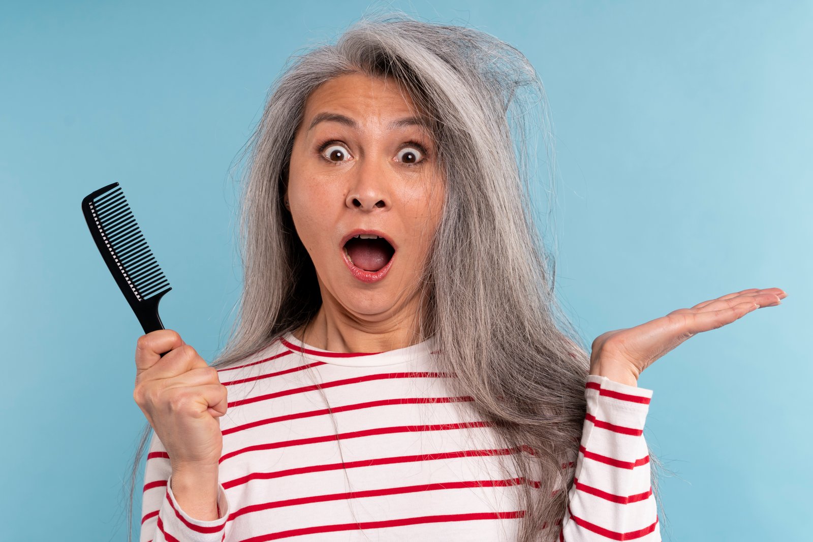 Woman applying hair oil to dry ends