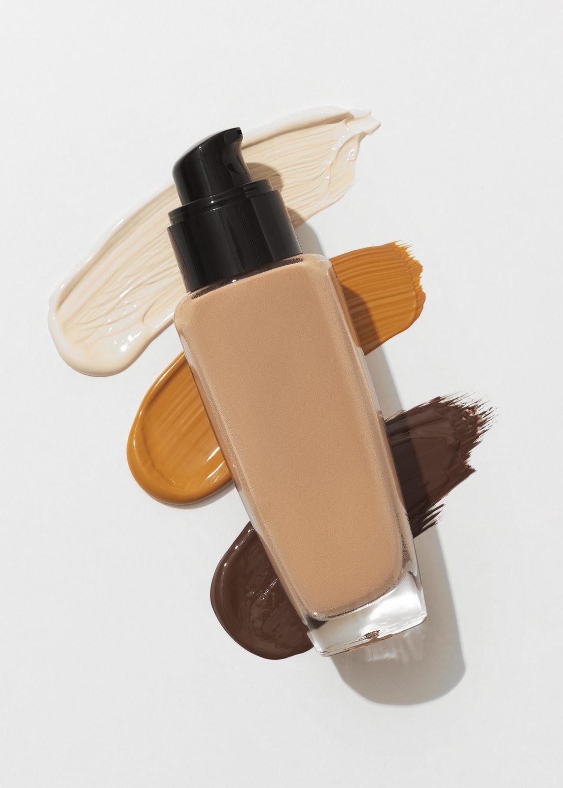 Foundation bottle with shade swatches in a range of skin tones
