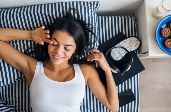 Woman applying scalp serum as part of a nighttime hair routine